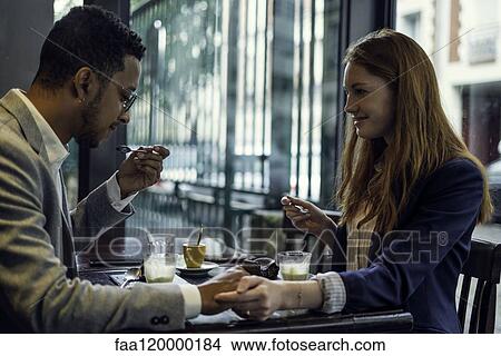 Picture - Couple eating dessert. Fotosearch