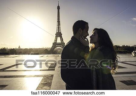 Couple embracing at Eiffel Tower View Large Photo Image Stock Photo - Couple embracing at Eiffel Tower. Fotosearch