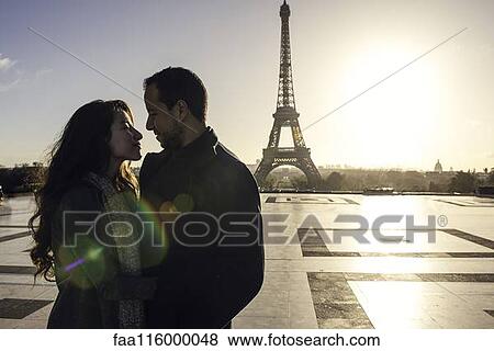 Stock Photo - Couple embracing at Eiffel Tower. Fotosearch