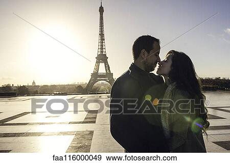 Couple embracing at Eiffel Tower View Large Photo Image Stock Photo - Couple embracing at Eiffel Tower. Fotosearch