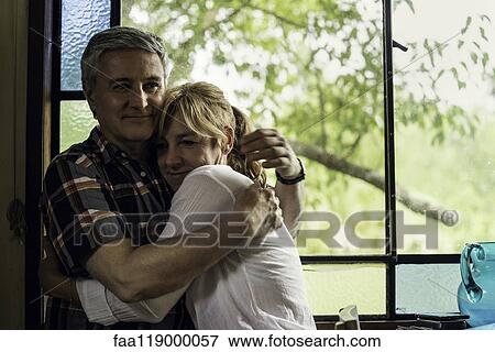 Stock Photo - Couple embracing at home. Fotosearch