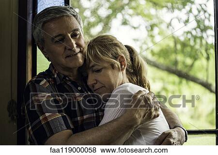 Couple embracing at home View Large Photo Image Stock Photo - Couple embracing at home. Fotosearch