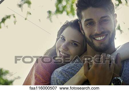 Stock Photo - Couple embracing each other in park. Fotosearch