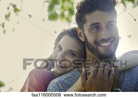 Couple embracing each other in park View Large Photo Image Stock Photo - Couple embracing each other in park. Fotosearch