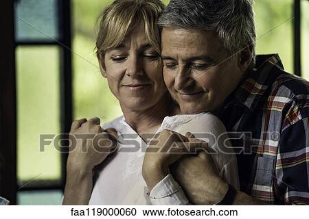 Couple embracing indoors View Large Photo Image Stock Image - Couple embracing indoors. Fotosearch