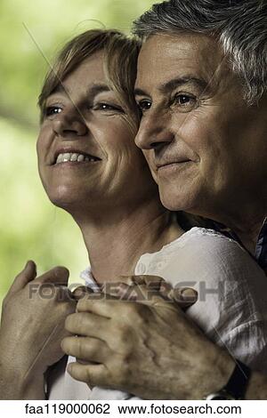 Stock Image - Couple embracing indoors. Fotosearch