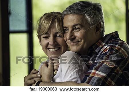 Stock Image - Couple embracing indoors. Fotosearch