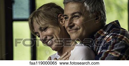 Stock Photography - Couple embracing indoors. Fotosearch