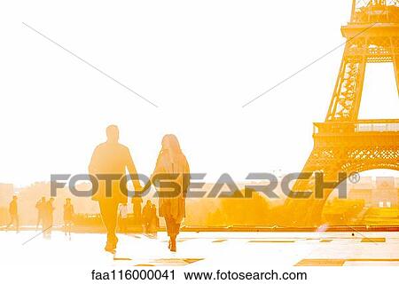 Couple holding hands near Eiffel Tower View Large Photo Image Stock Image - Couple holding hands near Eiffel Tower. Fotosearch