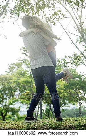 Couple hugging in park View Large Photo Image Stock Image - Couple hugging in park. Fotosearch