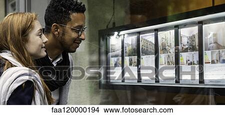 Couple looking at window display View Large Photo Image Picture - Couple looking at window display. Fotosearch