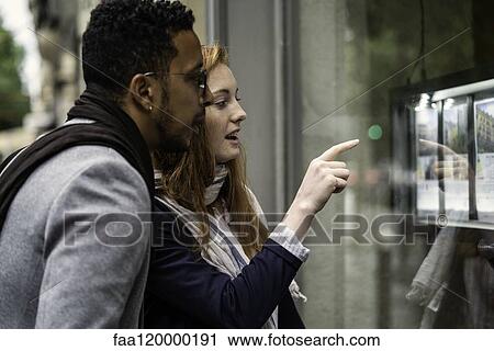 Couple looking at window display View Large Photo Image Stock Image - Couple looking at window display. Fotosearch