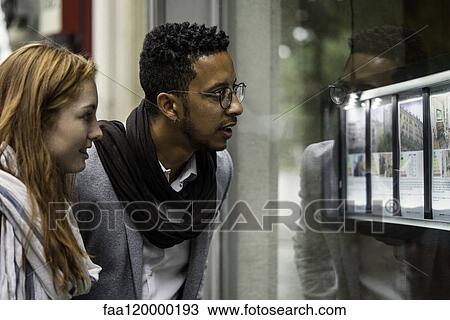 Couple looking at window display View Large Photo Image Stock Image - Couple looking at window display. Fotosearch