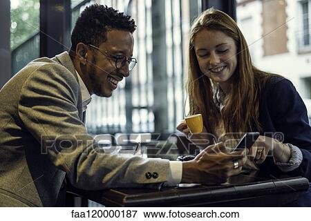 Couple sitting in caf View Large Photo Image Stock Photo - Couple sitting in caf. Fotosearch