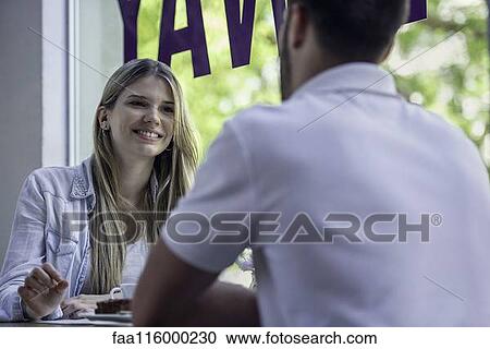 Couple sitting in cafe View Large Photo Image Stock Image - Couple sitting in cafe. Fotosearch