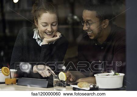 Couple sitting in restaurant View Large Photo Image Stock Image - Couple sitting in restaurant. Fotosearch