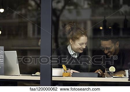 Couple sitting in restaurant View Large Photo Image Stock Image - Couple sitting in restaurant. Fotosearch