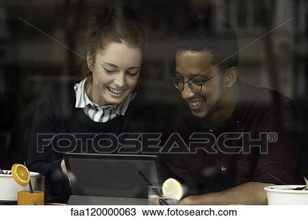 Couple sitting in restaurant View Large Photo Image Stock Image - Couple sitting in restaurant. Fotosearch