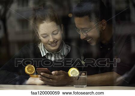 Stock Photo - Couple sitting in restaurant. Fotosearch