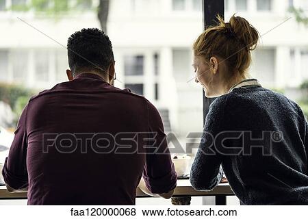 Couple sitting in restaurant View Large Photo Image Stock Photo - Couple sitting in restaurant. Fotosearch