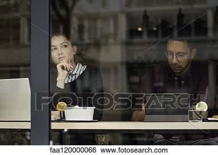 Couple sitting in restaurant View Large Photo Image Stock Photograph - Couple sitting in restaurant. Fotosearch