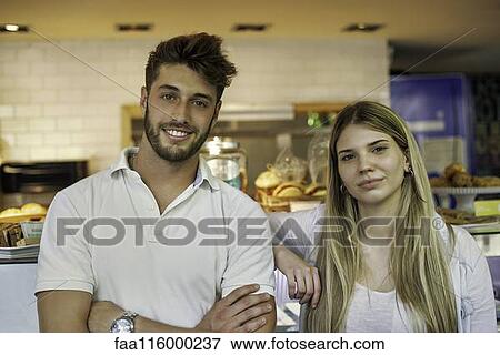 Couple standing in cake shop View Large Photo Image Stock Photo - Couple standing in cake shop. Fotosearch
