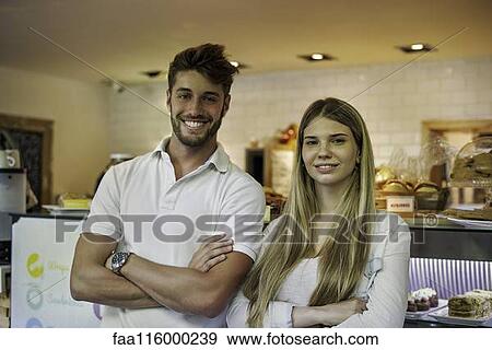 Couple standing in cake shop View Large Photo Image Stock Photo - Couple standing in cake shop. Fotosearch