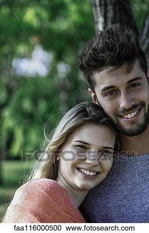 Couple standing in park View Large Photo Image Stock Image - Couple standing in park. Fotosearch