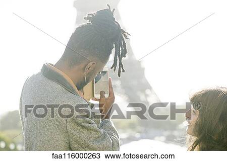 Couple taking photograph of Eiffel Tower View Large Photo Image Stock Image - Couple taking photograph of Eiffel Tower. Fotosearch
