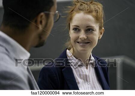 Picture - Couple talking outdoors. Fotosearch