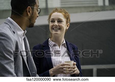 Stock Image - Couple talking outdoors. Fotosearch