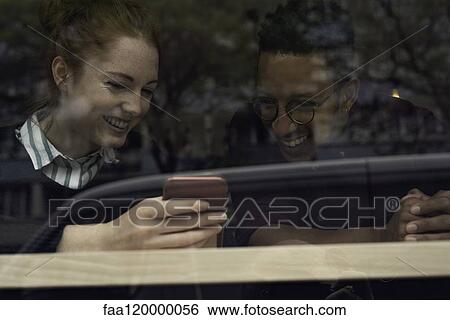 Couple using smart phone View Large Photo Image Stock Photograph - Couple using smart phone. Fotosearch