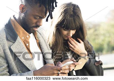 Couple using smartphone View Large Photo Image Stock Image - Couple using smartphone. Fotosearch