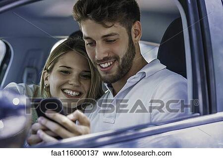 Couple using smartphone View Large Photo Image Stock Photo - Couple using smartphone. Fotosearch