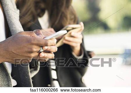 Couple using smartphone View Large Photo Image Stock Photograph - Couple using smartphone. Fotosearch