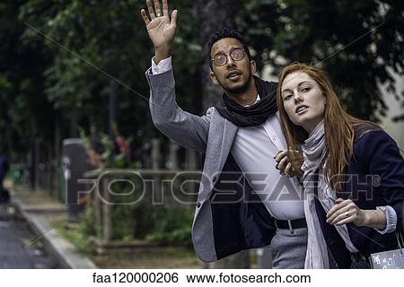 Couple waiting for taxi View Large Photo Image Stock Photograph - Couple waiting for taxi. Fotosearch