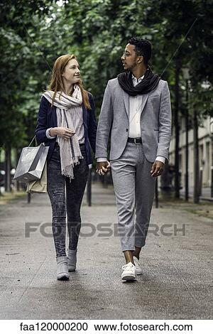 Couple walking on street View Large Photo Image Stock Image - Couple walking on street. Fotosearch