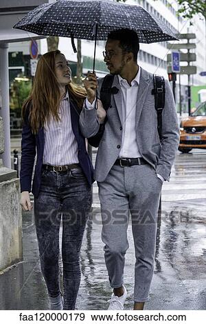Couple walking on street View Large Photo Image Stock Photo - Couple walking on street. Fotosearch