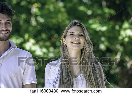 Couple walking together in park View Large Photo Image Stock Image - Couple walking together in park. Fotosearch