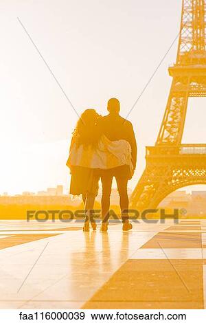 Stock Photo - Couple walking towards Eiffel Tower. Fotosearch
