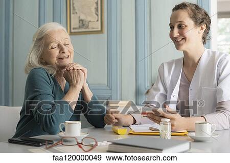 Doctor and patient sitting in clinic View Large Photo Image Stock Photo - Doctor and patient sitting in clinic. Fotosearch