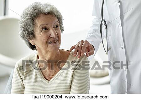 Doctor consoling senior woman View Large Photo Image Picture - Doctor consoling senior woman. Fotosearch