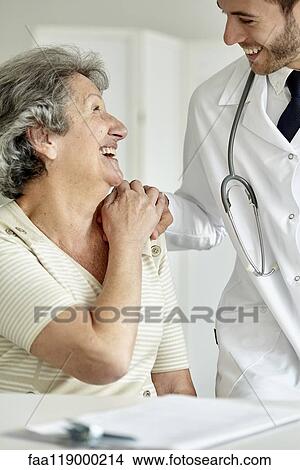 Doctor consoling senior woman View Large Photo Image Picture - Doctor consoling senior woman. Fotosearch