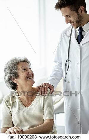 Doctor consoling senior woman View Large Photo Image Stock Image - Doctor consoling senior woman. Fotosearch
