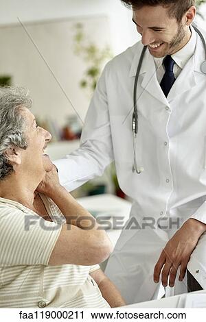 Doctor consoling senior woman View Large Photo Image Stock Image - Doctor consoling senior woman. Fotosearch