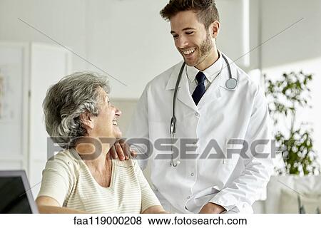 Doctor consoling senior woman View Large Photo Image Stock Photo - Doctor consoling senior woman. Fotosearch