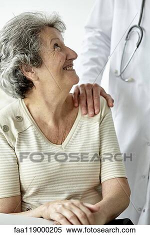 Doctor consoling senior woman View Large Photo Image Stock Photography - Doctor consoling senior woman. Fotosearch