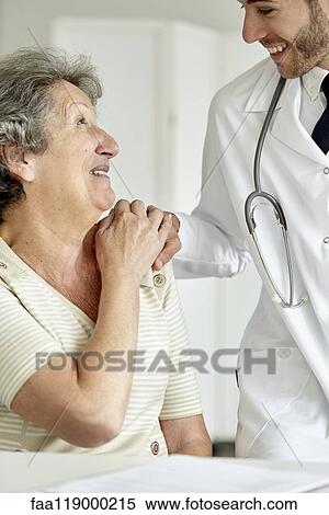 Stock Photography - Doctor consoling senior woman. Fotosearch