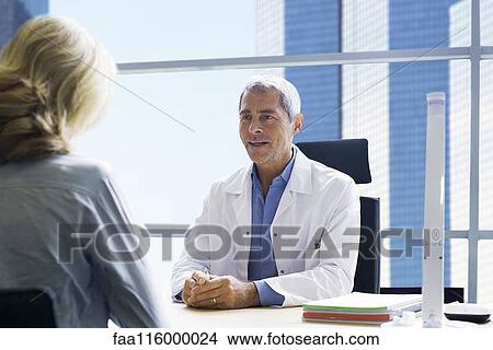 Doctor consulting patient in clinic View Large Photo Image Picture - Doctor consulting patient in clinic. Fotosearch