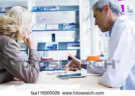 Doctor consulting patient in clinic View Large Photo Image Stock Photograph - Doctor consulting patient in clinic. Fotosearch